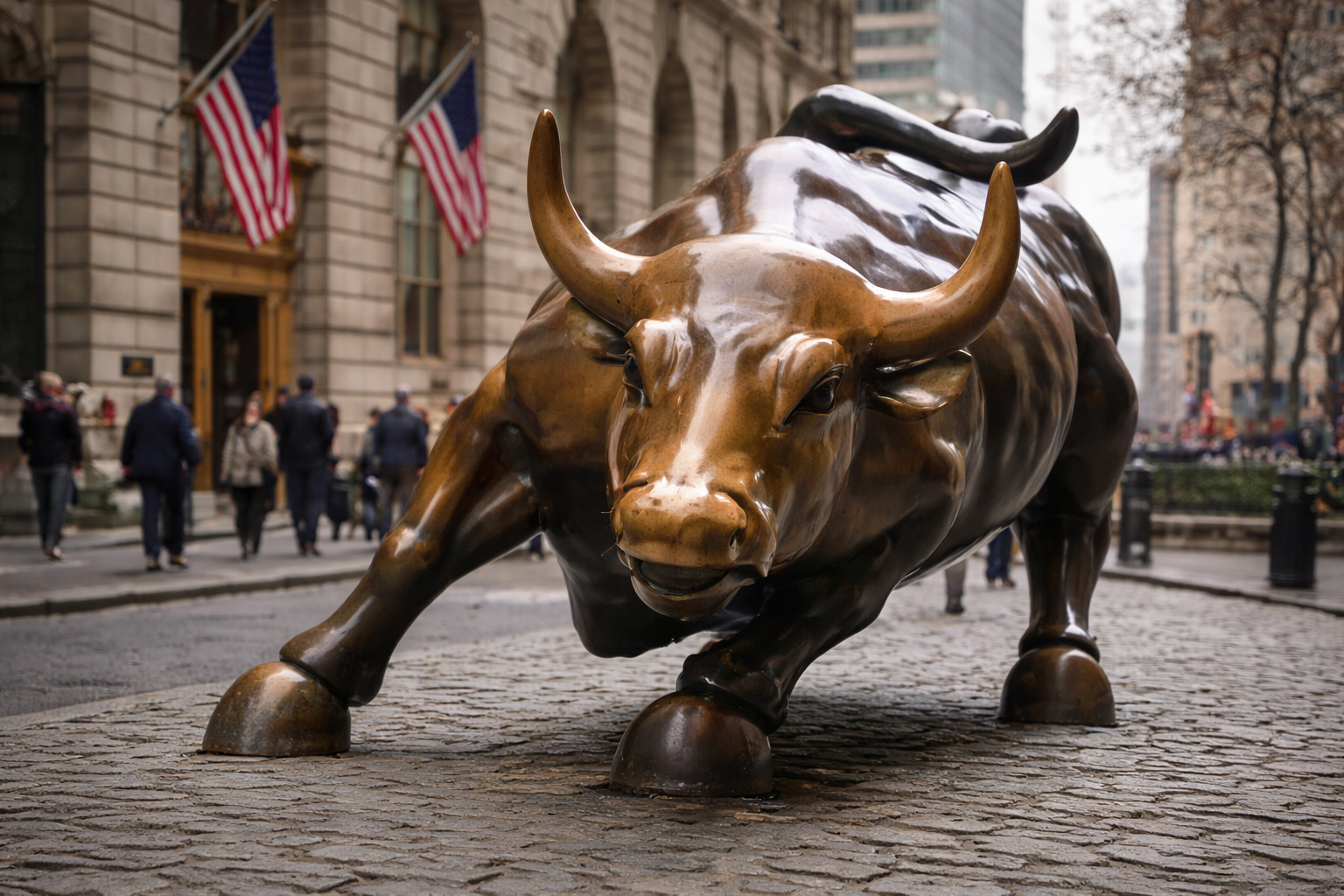 The Charging Bull statue stands on Wall Street with American flags in the background.