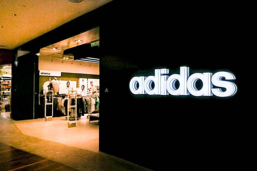 Adidas reported first-quarter operating profit of €705 million, beating analyst estimates as strong demand for apparel, football products.