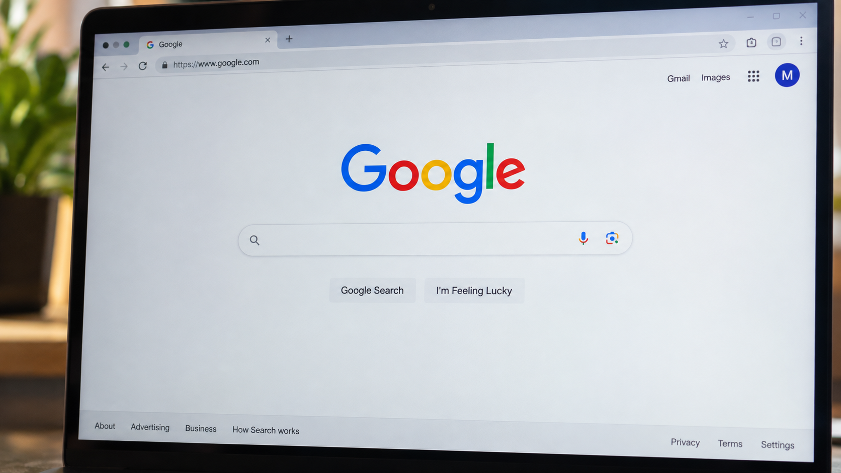 Google Search homepage displayed on a laptop screen, with the Google logo and search bar visible.