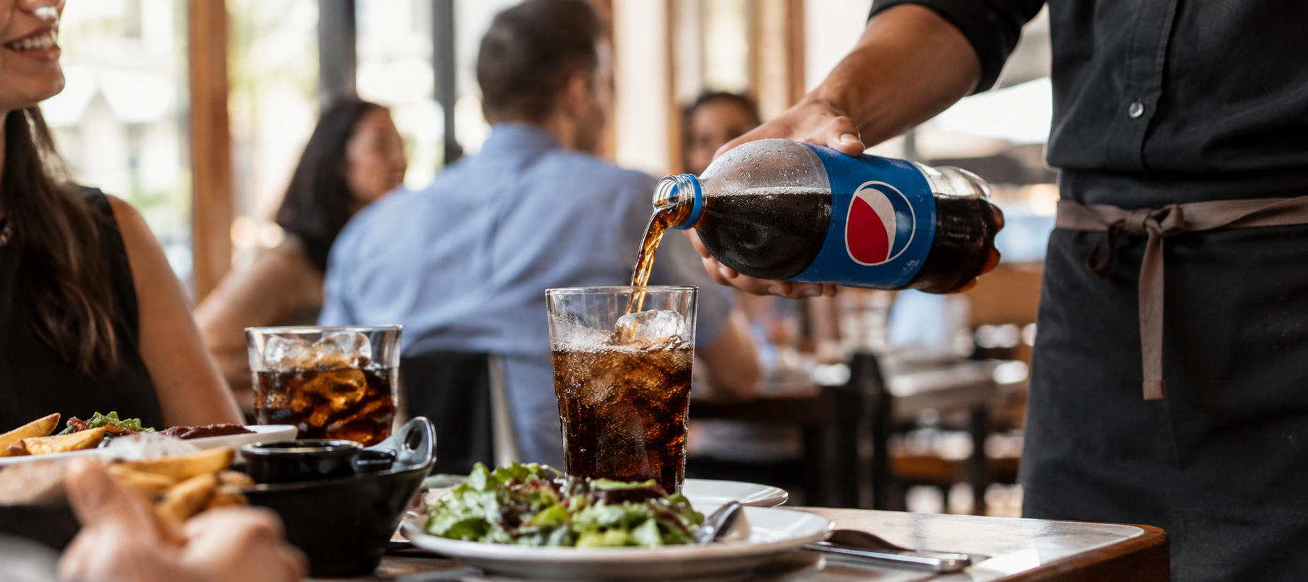 Pepsi being poured to glasses